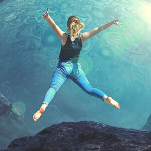 Woman leaping into a blue imaginary planet. Leap Into Your Fears!